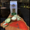 Dill Crackers with cucumber slices, cream cheese, and smoked salmon on a wooden board.